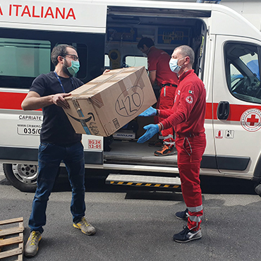 Man giving box to ambulance staff