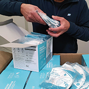 Man putting masks in boxes