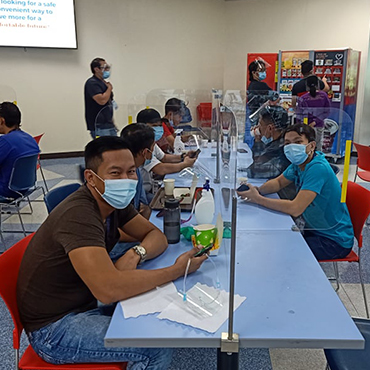 Staff wearing masks in a canteen