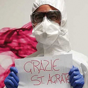 Woman in full protective gear holding sign