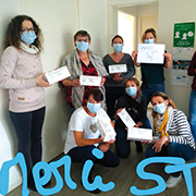 Administrative staff with masks holding signs