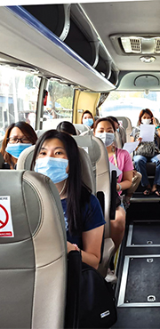 People on a bus wearing masks