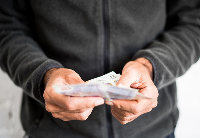 Person holding money in their hands (photo)