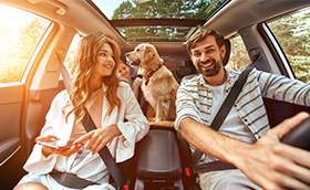 view inside the car with a family of three with a dog (photo)